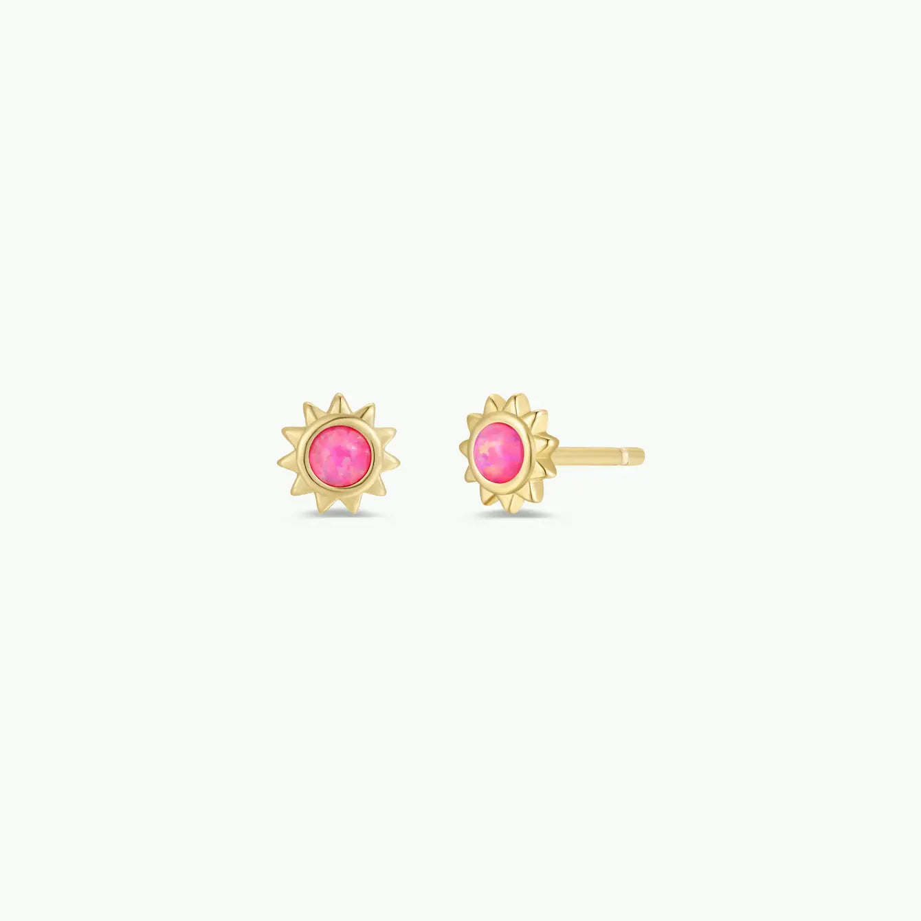 The JaxKelly Pink Opal Sun Stud earrings feature jagged gold rays and round Pink Opal centers, shown on a white background.