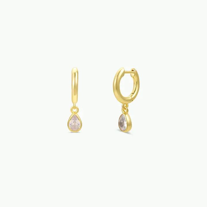 A pair of Teardrop Charm Hoop - White CZ earrings, each featuring a dangling, teardrop-shaped stone.
