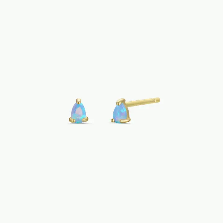 The JaxKelly Teardrop Stud - Fire Opal earrings are a pair of small gold studs featuring brilliant, teardrop-shaped fire opal stones. Shown against a plain white background, these hypoallergenic earrings are designed for comfortable everyday wear.