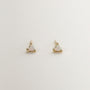 The Tiny White Opal Heart earrings are delicate, gold-plated studs with heart-shaped lab-grown white opal stones, shown on a plain light-colored background.