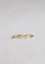 A pair of delicate Star Huggie gold rings with petite star-shaped designs and central stones complements your favorite 18k gold plated earrings, all showcased on a plain white background.