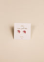 The Pink Opal Crown earrings, shaped like pink crescent moons with lab-grown Pink Opal and 18k gold plating, are shown on a white JAXKELLY wear good vibes OPAL joy card, set against a beige background.