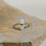 The Amazonite Point Ring is a minimalist gold ring featuring a light blue, pointed Amazonite stone set vertically atop a textured band.