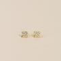 A pair of Pavé Mushroom small, gold-plated triangular stud earrings with a textured finish and sparkling CZ accents, displayed on a plain light beige background.