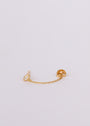 The Stud Chain Huggie features a delicate 18k gold plated stud with a small clear gemstone and a thin gold chain linking the stud to the backing, shown on a plain light background.