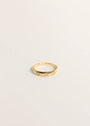 The Inset Baguette Ring is a thin gold band featuring small rectangular baguette-cut stones spaced evenly around it, shown on a simple light background.