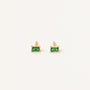 The Emerald Baguette features gold-plated stud earrings, each set with a small rectangular green gemstone, shown against a plain white background.