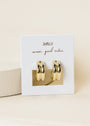 A pair of Bold Hoop 18k gold plated chunky earrings are displayed on a white JaxKelly card reading "wear good vibes" in cursive, set against a soft beige background.