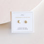 The Sun & Moon earrings set features one 18k gold plated crescent moon with a gem and one starburst with a gem, displayed on a card that reads LIVE BY THE SUN, LOVE BY THE MOON.