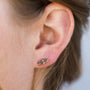 Close-up of a woman's ear wearing the Rose Gold Bar Druzy earring—a small, elegant rectangular stud with sparkling stones. Her light brown hair is tucked behind her ear, highlighting the earring’s refined shine.