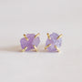 The Amethyst Gemstone Prong - Healing earrings feature raw, light purple amethyst stones set in simple gold-plated prongs, shown on a plain white background.