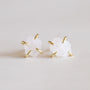 A pair of Rose Quartz Gemstone Prong - Love stud earrings featuring raw white stones in four 18K gold-plated prongs, shown on a light neutral background.