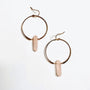The Rose Quartz Hoop - Love earrings feature handcrafted gold hoops with hanging rose quartz pendants, beautifully displayed on a white background.