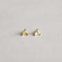 A pair of Citrine - Mini Energy Gems - Success studs, featuring small triangular yellow gemstones with 18k gold plating and sterling silver posts, shown on a plain light gray background.
