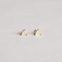 A pair of Rose Quartz Mini Energy Gems - Love: small, triangular studs with 18k gold plating and translucent rose quartz stones on sterling silver posts, displayed against a simple light background.