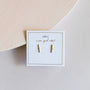 Minimalist Bar earrings in 18k gold plated sterling silver are shown on a white card with gold JaxKelly "wear good vibes" text, set against a clean, light background.