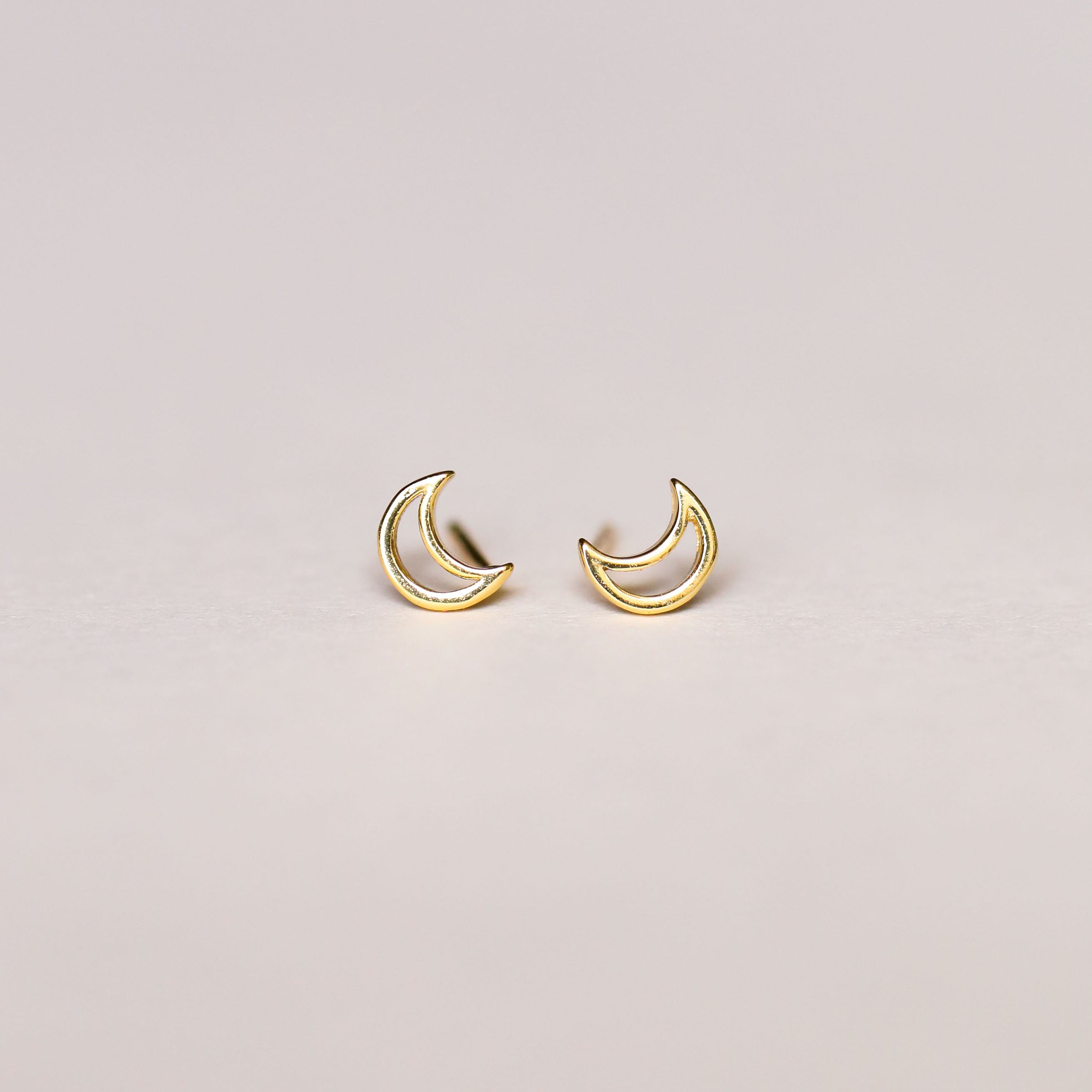 Minimalist Moon: small 18k gold plated hollow moon earrings displayed on a plain, light background—an elegant addition to any sterling silver jewelry collection.
