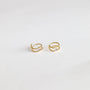 A pair of Minimalist Spiral earrings featuring a double spiral design with 18k gold plating, shown on a plain white background.