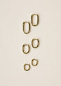 Six small rectangular hoops with elegant gold plating are arranged vertically on a light beige surface.