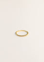 The Half Pavé Ring is a delicate, minimalist gold-plated ring featuring small cubic zirconia stones across the top, showcased on a plain light background.