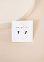 The Offset Trio - Sapphire earrings are displayed on a white card with gold "JaxKelly wear good vibes" lettering, set against a soft beige background.