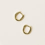 The Small Rectangular Hoop earrings feature chunky, slightly squared gold rectangles with sterling silver posts and radiant gold plating, resting on a plain, light-colored surface.