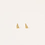 The Tiny Star earrings are mini stud earrings featuring single clear gemstones, an 18k gold plated finish, and sterling silver posts, shown against a plain white background.