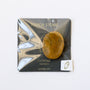The Citrine Touch Stone, a polished natural citrine gem, is mounted on a black TOUCH STONE card labeled "CITRINE SUCCESS," enclosed in a clear plastic bag with an outlined gemstone graphic and a small white sticker.
